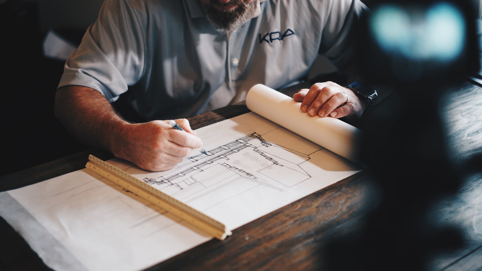 A builder reviewing house extension plans for a Leeds project